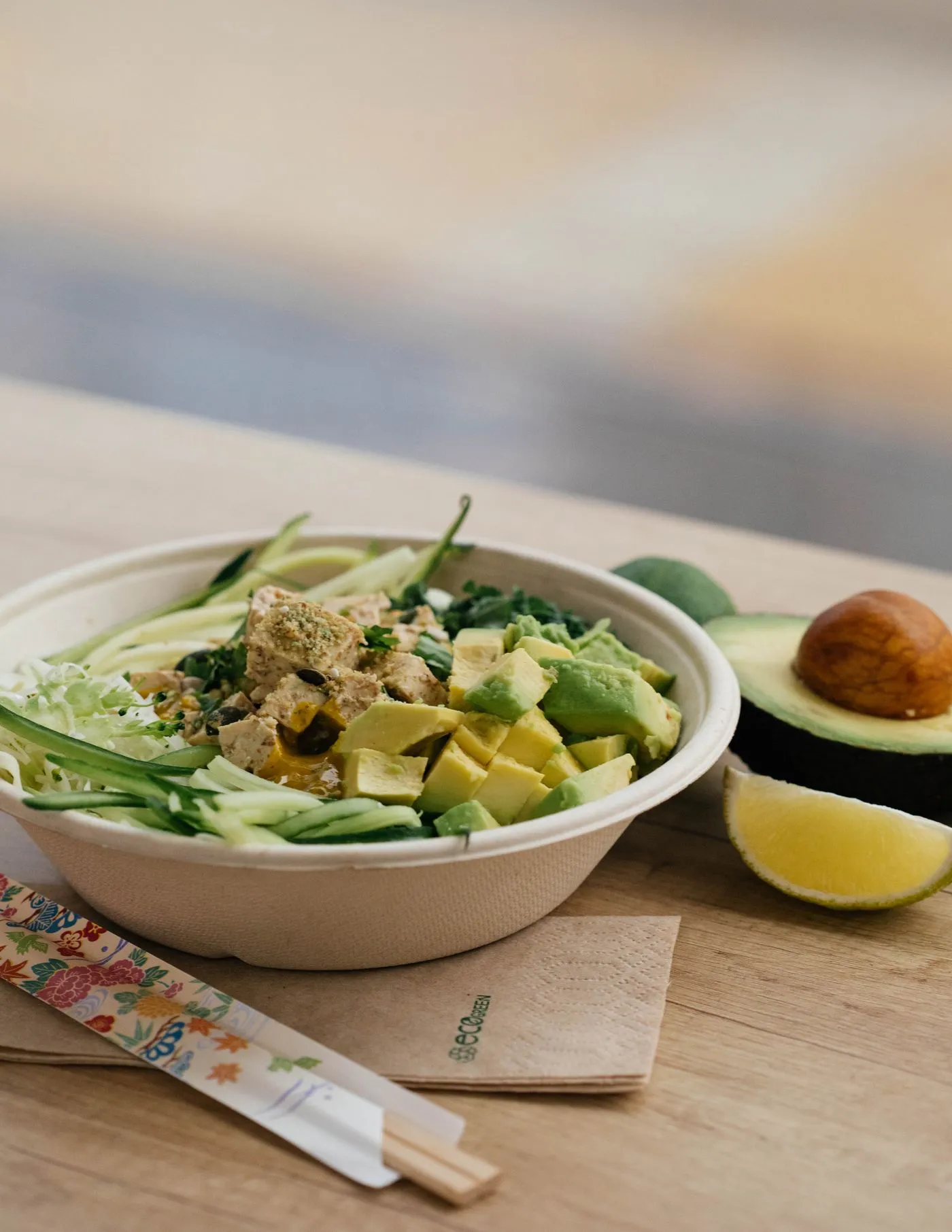 A bowl of avocado, tofu and fresh vegetables