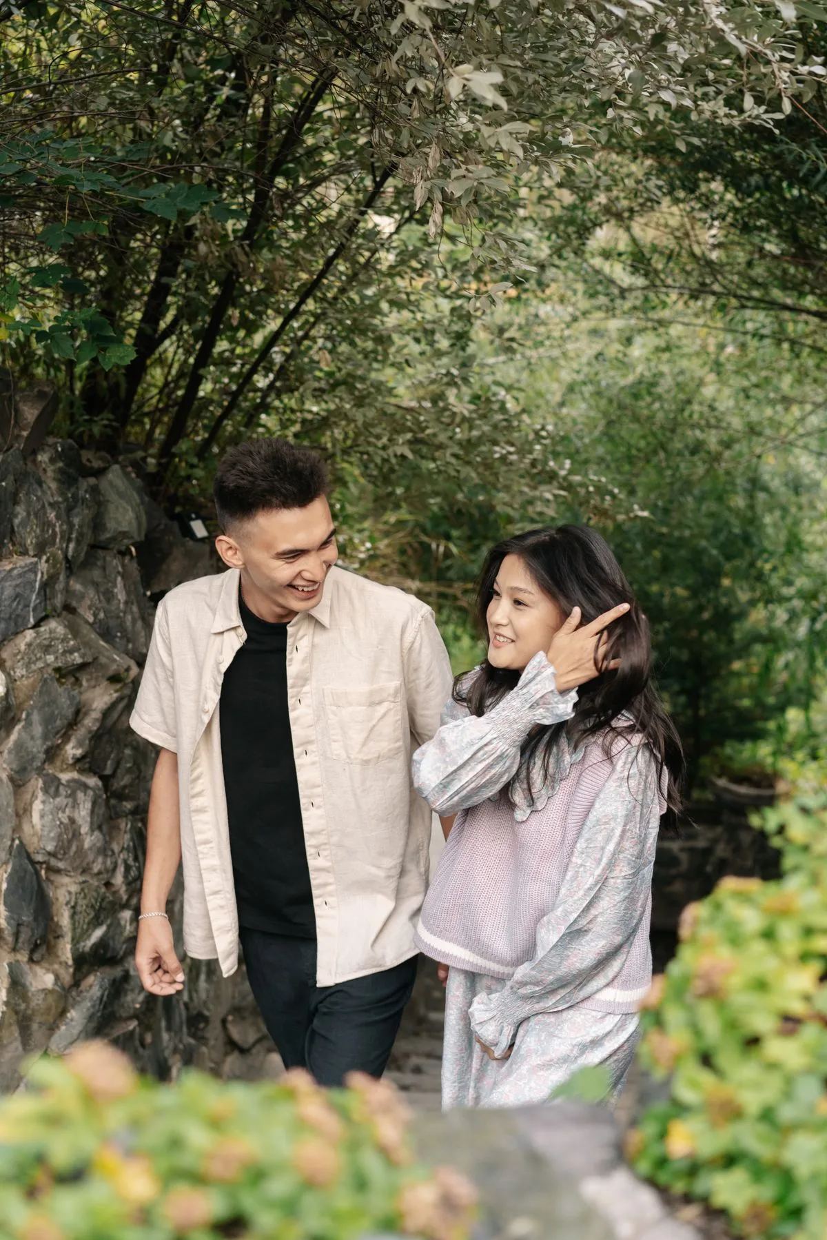 Two people enjoying a walk through a green garden
